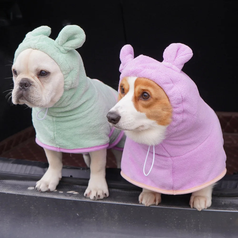 Two dogs in MuddyMate dog drying robes after a muddy walk, drying off in the car boot